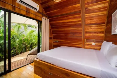 a bedroom with a bed and a large window at New 3BR Chalet-Style Villa Pasak Paradise 3, Private Pool, 10min drive to Laguna Phuket in Bang Tao Beach
