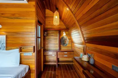 a room with a bed and a wooden wall at New 3BR Chalet-Style Villa Pasak Paradise 3, Private Pool, 10min drive to Laguna Phuket in Bang Tao Beach
