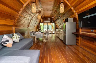 a living room with a couch and a refrigerator at New 3BR Chalet-Style Villa Pasak Paradise 3, Private Pool, 10min drive to Laguna Phuket in Bang Tao Beach