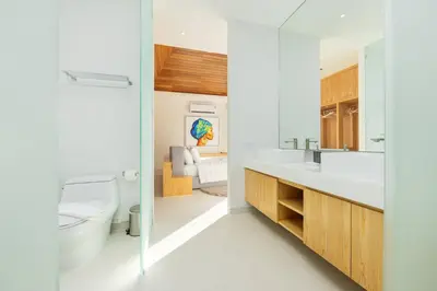 a white bathroom with a toilet and a sink at Luxury 3BR Villa Wallaya with Private Pool in Bang Tao Beach
