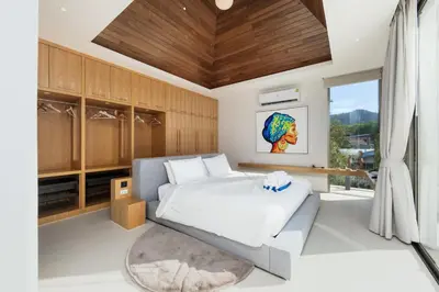 a bedroom with a large bed and a large window at Luxury 3BR Villa Wallaya with Private Pool in Bang Tao Beach