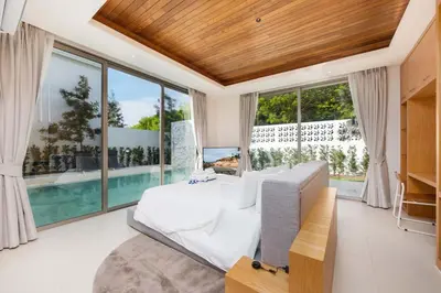 a bedroom with a bed and a swimming pool at Luxury 3BR Villa Wallaya with Private Pool in Bang Tao Beach