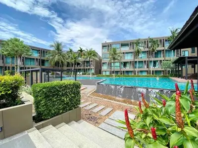 a large apartment building with a swimming pool at The Pixel Cap Panwa Sea front Condominium - By Lovly in Ban Ao Makham