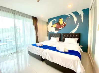 a bedroom with a superhero mural on the wall at The Pixel Cap Panwa Sea front Condominium - By Lovly in Ban Ao Makham