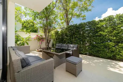 an outdoor patio with wicker chairs and a table at Phuket villa in Laguna in Bang Tao Beach