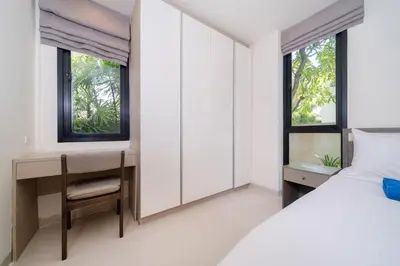 a bedroom with a bed and a desk and windows at Phuket villa in Laguna in Bang Tao Beach