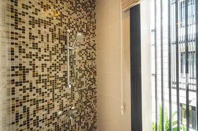a bathroom with a shower with mosaic tiles on the wall at Phuket villa in Laguna in Bang Tao Beach