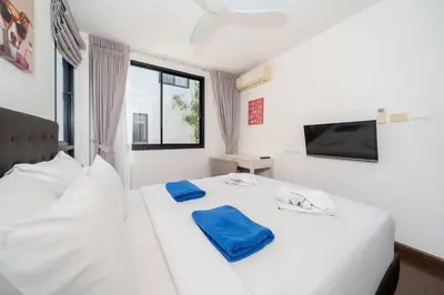a bedroom with a white bed with blue towels on it at Phuket villa in Laguna in Bang Tao Beach