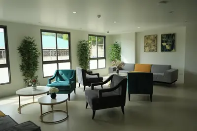 a living room with couches and chairs and tables at Premium 2BR near Kamala Beach, Pool, Gym & Shuttle Bus in Phuket Town