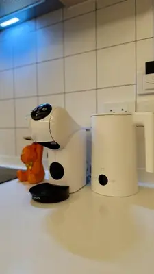a robot is standing next to a toaster on a counter at Premium 2BR near Kamala Beach, Pool, Gym & Shuttle Bus in Phuket Town