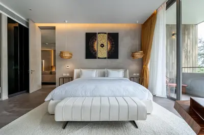 a bedroom with a large white bed and a large window at Luxury Penthouse 407sqm Beachfront and private pool in Phuket Town