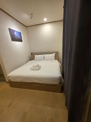 a bedroom with a bed with white sheets at ASAP Boutique Phuket in Ban Thalat Choeng Thale