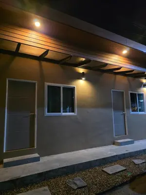 a building with two windows on the side of it at ASAP Boutique Phuket in Ban Thalat Choeng Thale