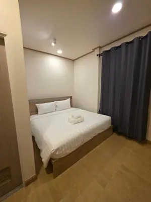 a small bedroom with a bed with white sheets at ASAP Boutique Phuket in Ban Thalat Choeng Thale