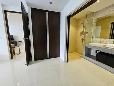 a bathroom with a sink and a large mirror at Stylish 2 Bedroom Apartment with pool access in Surin in Surin Beach