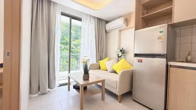 a kitchen and a living room with a couch and a refrigerator at Fantasea Kamala 1 BR Near Fantasea Show & Beach 505 in Phuket Town