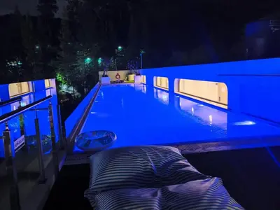 a swimming pool lit up at night with a pillow at Fantasea Kamala 1 BR Near Fantasea Show & Beach 505 in Phuket Town