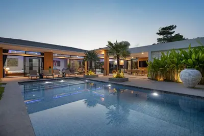 a swimming pool in front of a house at Stylish 4 bdrs new brand pool villa at Rawai kokmakham 1 in Rawai Beach