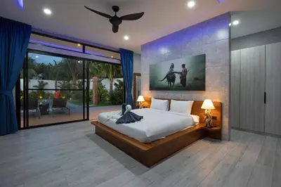 a bedroom with a large bed and a large window at Stylish 4 bdrs new brand pool villa at Rawai kokmakham 1 in Rawai Beach