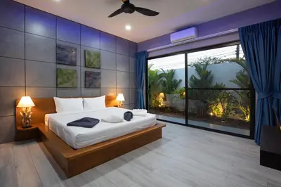 a bedroom with a large bed and a large window at Stylish 4 bdrs new brand pool villa at Rawai kokmakham 1 in Rawai Beach