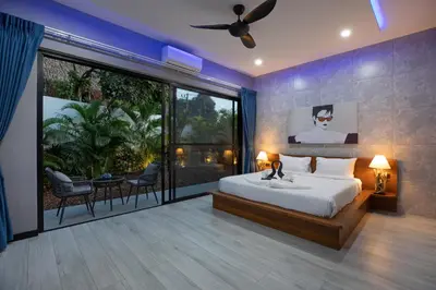a bedroom with a large bed and a large window at Stylish 4 bdrs new brand pool villa at Rawai kokmakham 1 in Rawai Beach