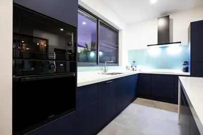 a kitchen with blue cabinets and a sink and a window at Superb 3-bedrooms pool villa in Rawai, Naiharn villa Moana in Rawai Beach