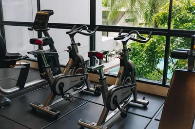 a row of exercise bikes in a gym at Solara Stays Phuket in Bang Tao Beach
