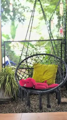 a swing chair with a pillow and a pillow at Rosemary Phuket in Ban Tha Rua