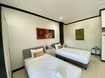 two beds in a room with two beds sidx sidx sidx sidx at Wink City 4th Patong in Patong Beach