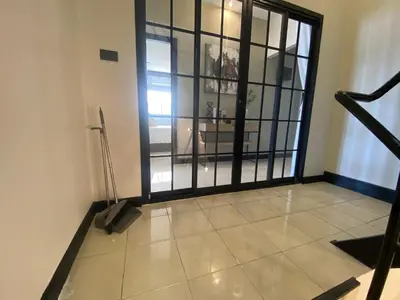 a room with a large glass door with a balcony at Wink City 4th Patong in Patong Beach