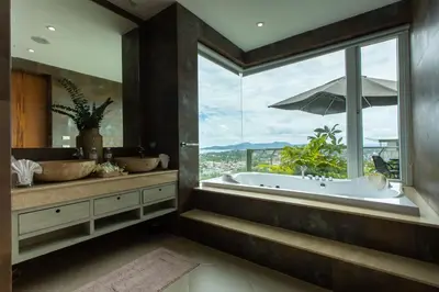 a bathroom with a tub and a large window at Seaview 10 bedroom villa Bangtao beach area in Ban Thalat Choeng Thale