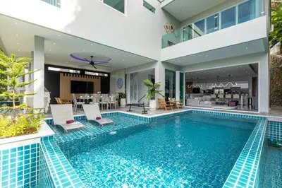 a swimming pool in the middle of a villa at Seaview 10 bedroom villa Bangtao beach area in Ban Thalat Choeng Thale
