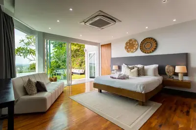 a bedroom with a bed and a couch at Seaview 10 bedroom villa Bangtao beach area in Ban Thalat Choeng Thale
