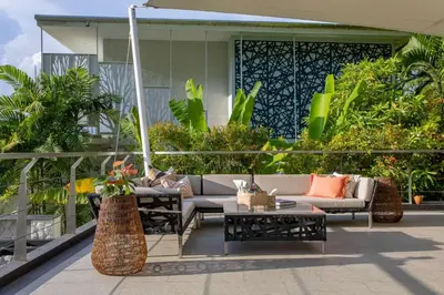 a patio with a couch and tables and plants at Seaview 10 bedroom villa Bangtao beach area in Ban Thalat Choeng Thale