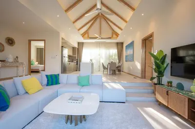 a living room with a white couch and a table at Modern 3BR Pool Villa T-Breeze in Laguna Phuket