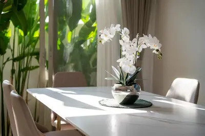 a white table with a vase of flowers on it at Modern 3BR Pool Villa T-Breeze in Laguna Phuket