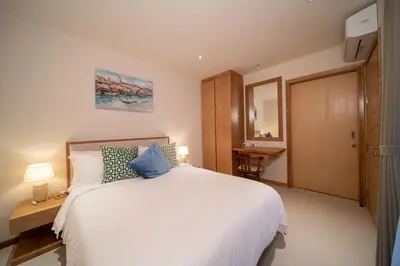 a bedroom with a large white bed and a desk at Modern 3BR Pool Villa T-Breeze in Laguna Phuket