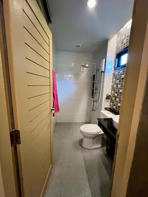 a bathroom with a toilet and a sink at Bang Tao cozy studio in Ban Thalat Choeng Thale