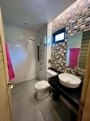 a bathroom with a white toilet and a sink at Bang Tao cozy studio in Ban Thalat Choeng Thale