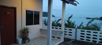a house with a balcony with a view of the ocean at Water's Edge Resort , in Panwa Beach