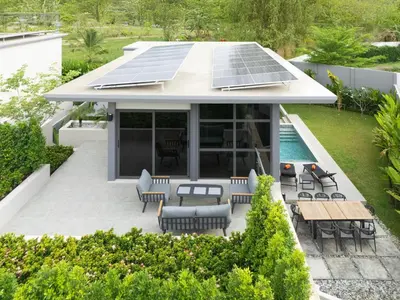 an image of a house with solar panels on the roof at Stylish Mansion for Leisure with Garden & Pool in Laguna Phuket