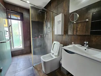 a bathroom with a toilet and a sink and a shower at Modern 3-Bedroom Townhome in Kamala in Kamala Beach