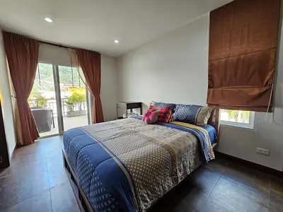 a bedroom with a bed with a blue comforter at Modern 3-Bedroom Townhome in Kamala in Kamala Beach