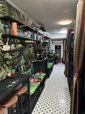 a room with shelves filled with green bananas at Tropical Vibes Mini Hostel in Phi Phi Don