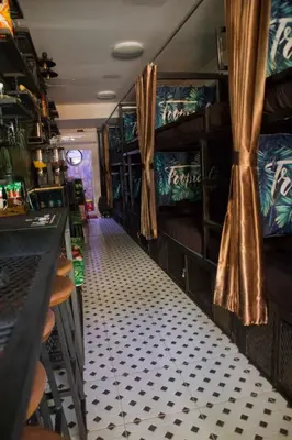 a room with a bar and a room with a bar at Tropical Vibes Mini Hostel in Phi Phi Don