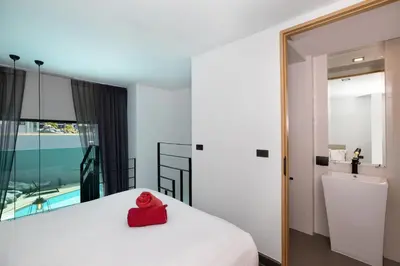 a red object sits on a bed in a room at Poolside Duplex In Nai harn UTL A102 in Rawai Beach