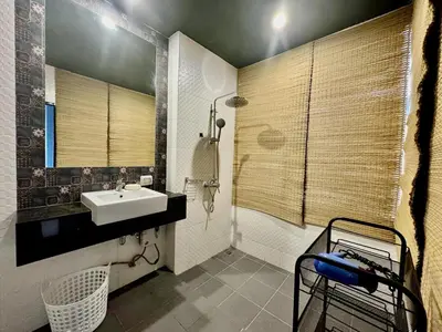 a bathroom with a sink and a mirror at Stylish Sea view Chic condo in Karon Beach