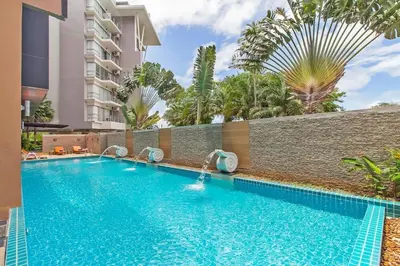 a swimming pool in front of a building at Stylish Sea view Chic condo in Karon Beach