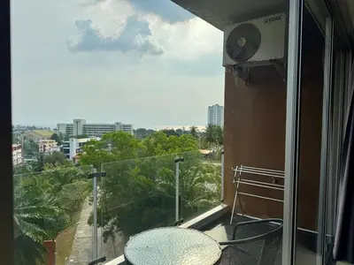 a balcony with a table and a view of a city at Stylish Sea view Chic condo in Karon Beach