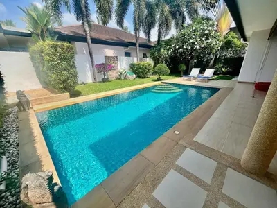 a swimming pool in front of a house at Stunning 2-Bedroom Pool Villa in Ban Thalat Choeng Thale
